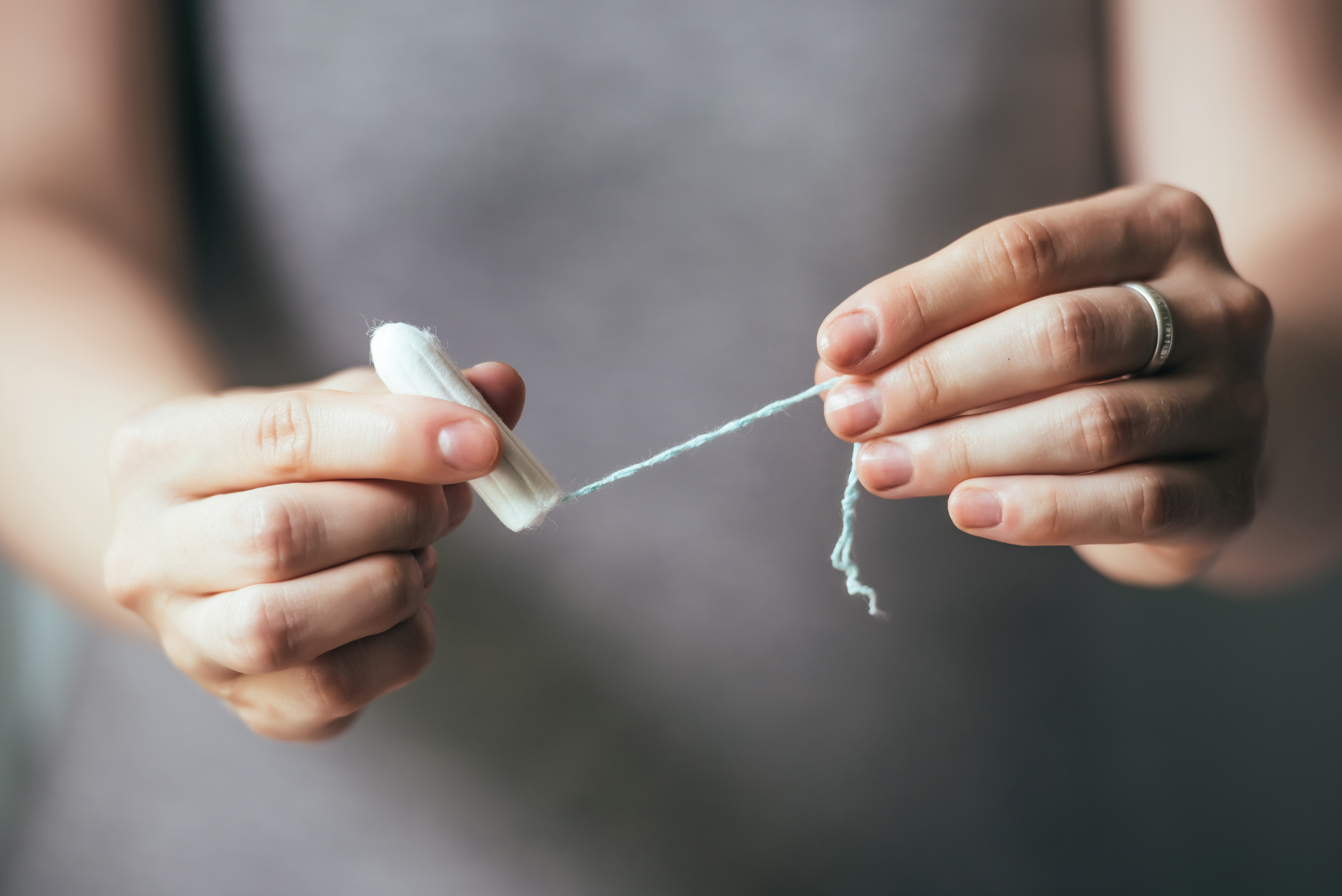 Person holding tampon between two hands